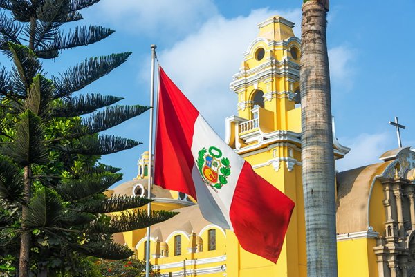 Peruvian flag and yellow church in the Barranco neighborhood in Lima Peru