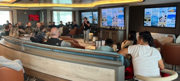 Group of people listening to a speech onboard the Ocean Albatros