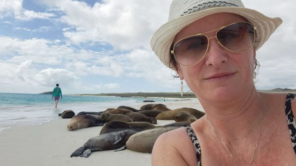 best places to solo travel. Rach founder of Viva with seals on the Galapagos Isl